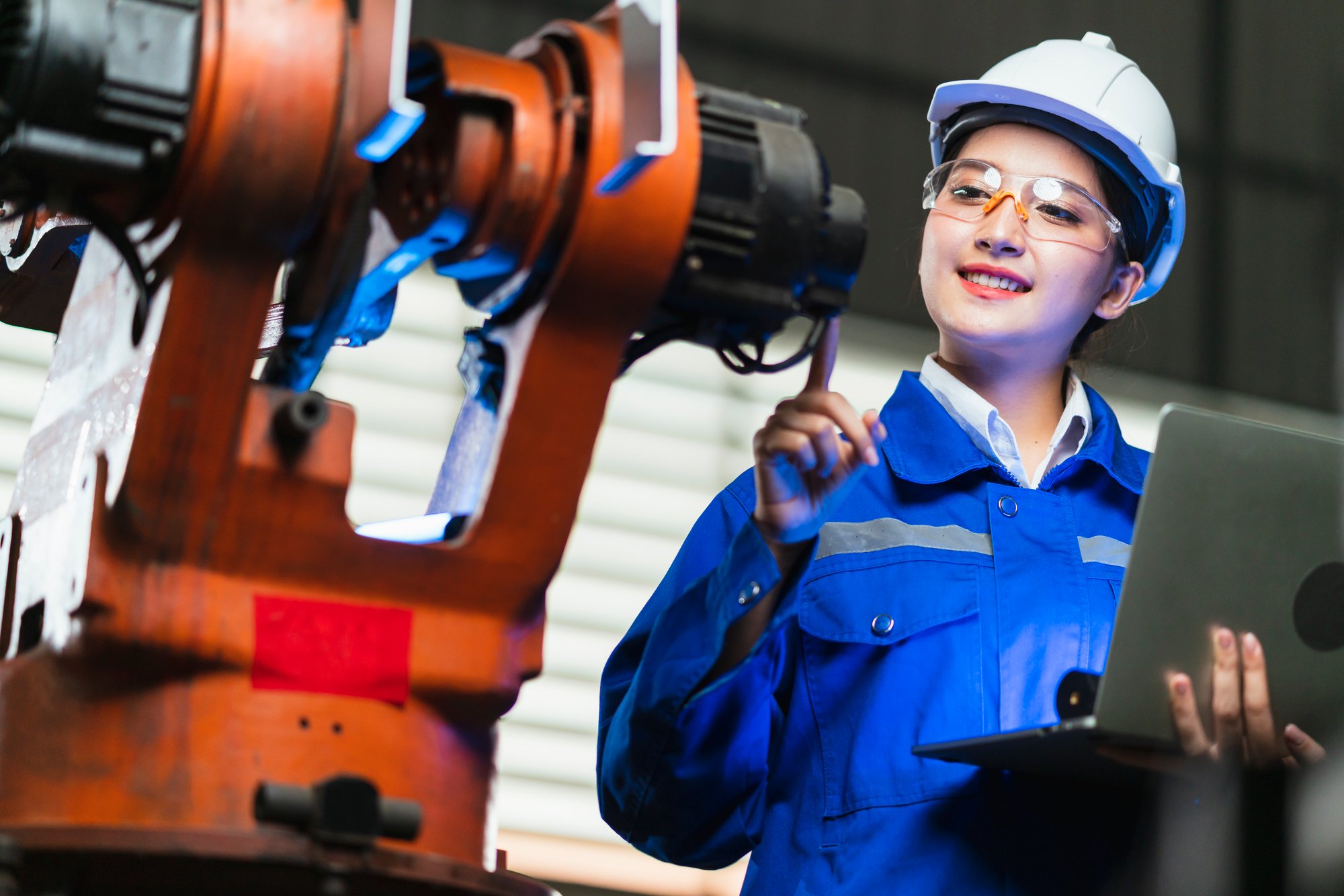 engineer-specialist-asian-female-technician-maintenance-inspect-relay-robot-arm-system-with-laptop-control-quality-operate-process-work-heavy-industry-40-manufacturing-smart-factory